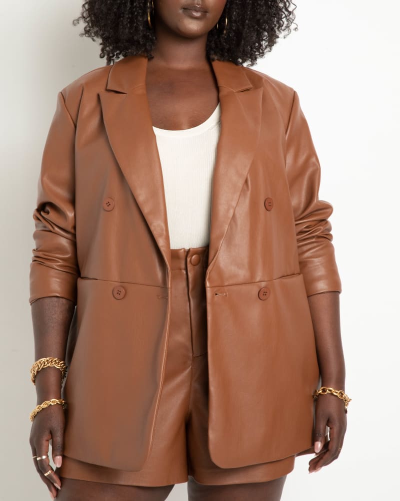 Front of a model wearing a size 14 Double Breasted Faux Leather Blazer in Sorrel Horse by ELOQUII. | dia_product_style_image_id:217031